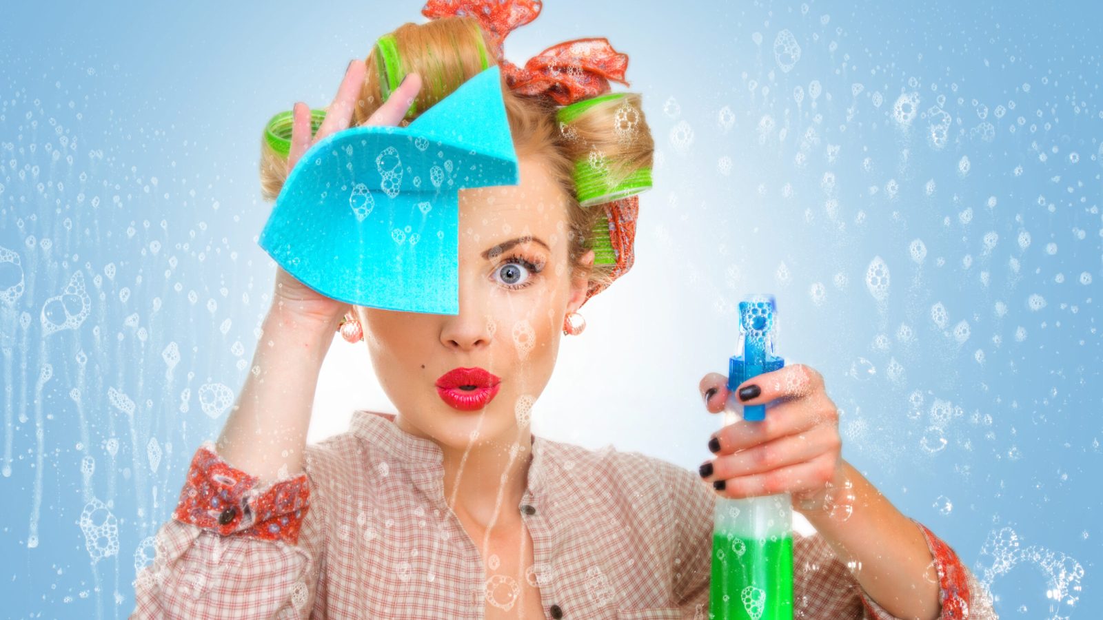 Funny housewife with rag / wipe and cleaning spray for window. Foam / soap on glass